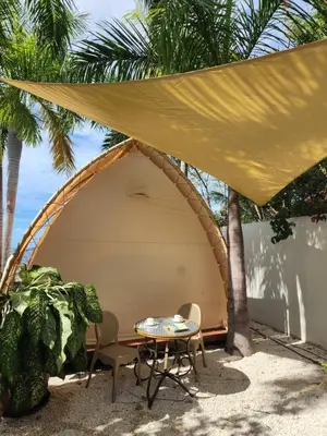 a tent on the beach with a table and chairs at A Slice of Paradise in Sardinal