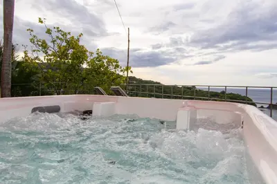 a jacuzzi tub with water in it on a balcony at A Slice of Paradise in Sardinal