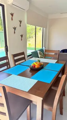 a dining room table with a bowl of fruit on it at Casa Colibrí Playa Blanca in Paquera