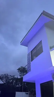 a white house with a blue sky in the background at Casa Colibrí Playa Blanca in Paquera