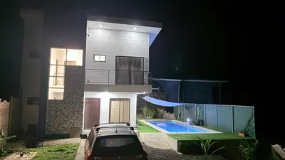 a car parked in front of a house at night at Casa Colibrí Playa Blanca in Paquera