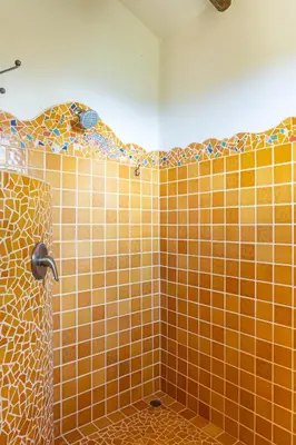 an orange tiled shower in a bathroom at Casa Sonora - Ocean View in Carrillo