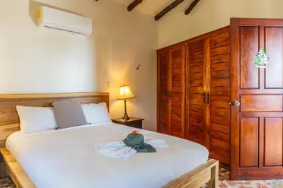 a bedroom with a bed with a stuffed animal on it at Casa Sonora - Ocean View in Carrillo
