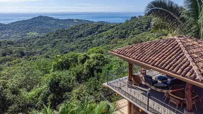 a balcony of a house with a view of the mountains at Casa Sonora - Ocean View in Carrillo