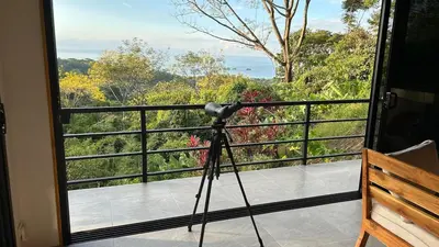 a camera on a tripod on a balcony with a view at Casa Selvática Wildlife-Happiness in Uvita