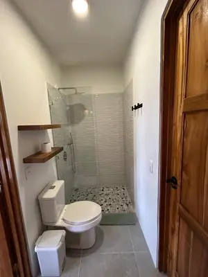a bathroom with a toilet and a shower at Casa Selvática Wildlife-Happiness in Uvita