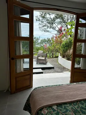 an open door to a patio with a view at Casa Selvática Wildlife-Happiness in Uvita