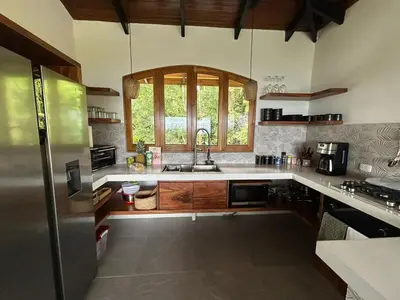 a large kitchen with a sink and a window at Casa Selvática Wildlife-Happiness in Uvita