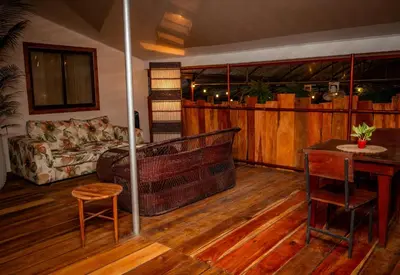 a living room with a couch and a table at Hotel La Pérgola in Sarapiquí