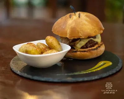 a sandwich and a bowl of food on a table at Hotel La Pérgola in Sarapiquí