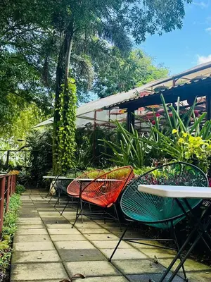 a group of chairs and tables on a patio at Hotel La Pérgola in Sarapiquí