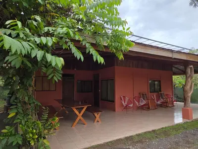 a patio of a house with chairs and a table at Casa Terracota in Bejuco