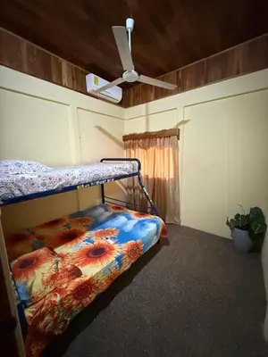 a bedroom with a bunk bed and a ceiling fan at Casa Terracota in Bejuco