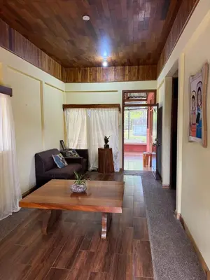 a living room with a table and a couch at Casa Terracota in Bejuco