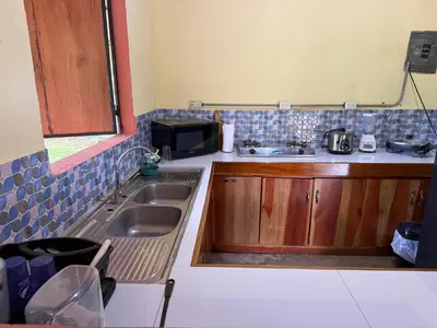 a small kitchen with a sink and a microwave at Casa Terracota in Bejuco