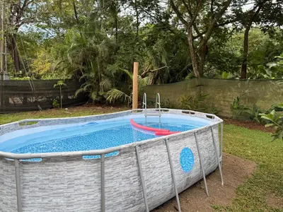 a pool with a boat in a yard at Casa Terracota in Bejuco