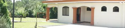 a small building with a door in a yard at Casa Andalucia Apartments in Santo Domingo