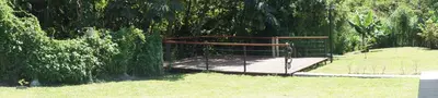 a metal gate in the grass in a park at Casa Andalucia Apartments in Santo Domingo