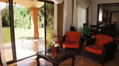 a living room with two chairs and a table at Casa Andalucia Apartments in Santo Domingo
