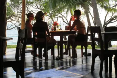 a group of people sitting at a table in a restaurant at Hotel Playa Negra in Playa Negra