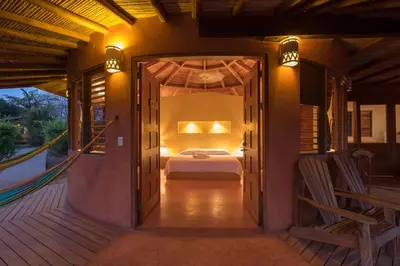 a bedroom with a bed on a deck at Hotel Playa Negra in Playa Negra