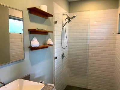 a bathroom with a shower and a sink at Screened-In Porch! Short Walk To Beach! in Sámara