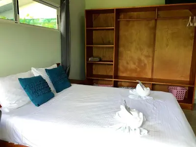 a bedroom with a bed with two white birds on it at Screened-In Porch! Short Walk To Beach! in Sámara