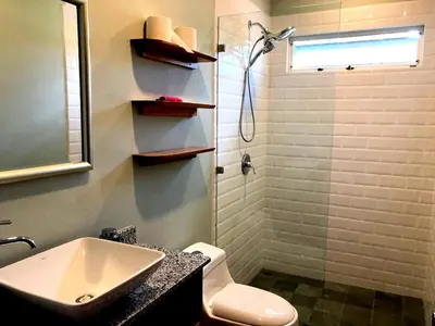 a bathroom with a sink and a shower and a toilet at Screened-In Porch! Short Walk To Beach! in Sámara