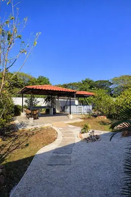 a walkway leading to a building with a pavilion at Casa Sol in Santa Rita