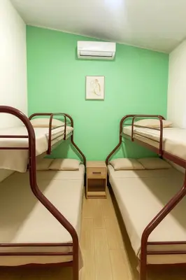 two bunk beds in a room with a green wall at Casa Sol in Santa Rita