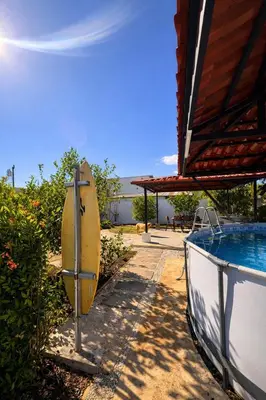 a surfboard is sitting next to a swimming pool at Casa Sol in Santa Rita