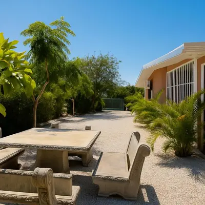 a patio with benches and a table in front of a building at Casa Sol in Santa Rita