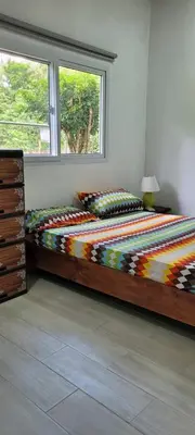 a bedroom with two beds and a window at CASA TICA Apart 1 y 2 in Potrero