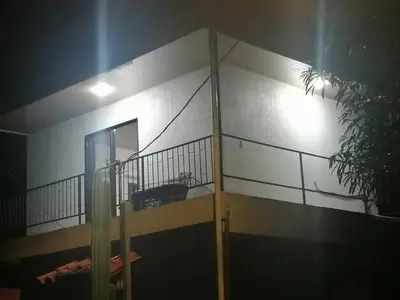 a building with a balcony with a light on it at CASA TICA Apart 1 y 2 in Potrero