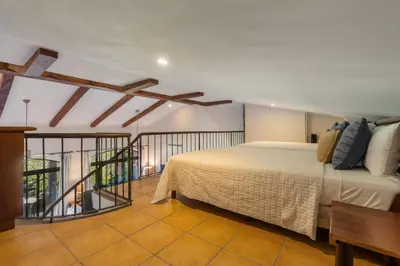 a bedroom with a bed and a balcony at Luxury Condo at Reserva Conchal with Incredible Ocean Views and Exclusive Beach Club Access in Brasilito
