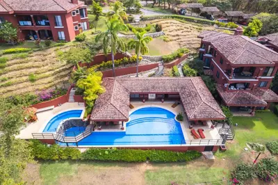 an aerial view of a house with a swimming pool at Luxury Condo at Reserva Conchal with Incredible Ocean Views and Exclusive Beach Club Access in Brasilito