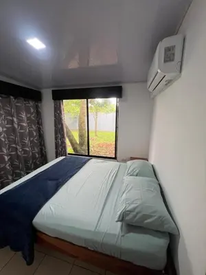 a bedroom with a large bed with a window at Casa Lapas in Guayabal