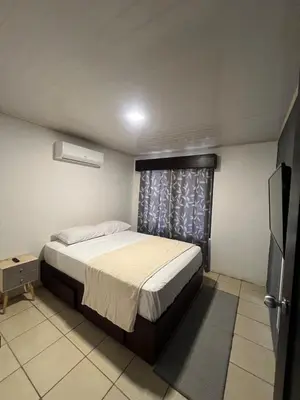 a small bedroom with a bed and a window at Casa Lapas in Guayabal