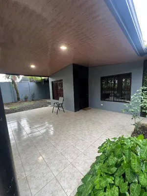 a patio with a chair and a plant at Casa Lapas in Guayabal