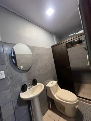 a bathroom with a toilet and a sink and a mirror at Casa Lapas in Guayabal