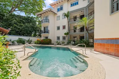 a swimming pool in front of a building at Tropical Balcony 10-minute walk to Adventures in Santa Cruz