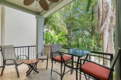 a patio with a table and chairs on a porch at Tropical Balcony 10-minute walk to Adventures in Santa Cruz