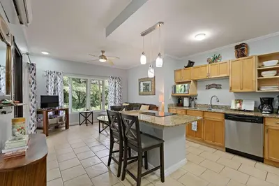 a kitchen with a counter and a dining room at Tropical Balcony 10-minute walk to Adventures in Santa Cruz