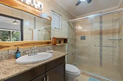 a bathroom with a shower and a sink and a toilet at Tropical Balcony 10-minute walk to Adventures in Santa Cruz