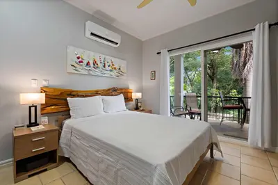 a bedroom with a large bed and a balcony at Tropical Balcony 10-minute walk to Adventures in Santa Cruz