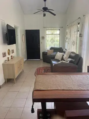 a living room with a couch and a table at Casa Zen in Potrero