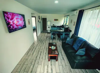 a living room with a couch and a table at Cabaña Tranquila en la Naturaleza in Tigra