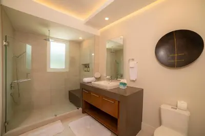 a bathroom with a sink and a shower and a toilet at Casa Blue Sail 6 bdr Ocean View in Herradura