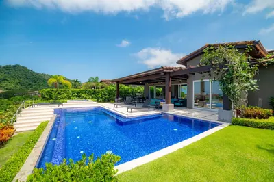 a swimming pool in the backyard of a villa at Casa Blue Sail 6 bdr Ocean View in Herradura