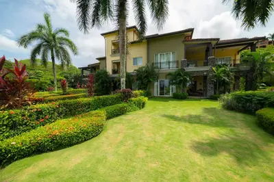 an exterior view of a house with a garden at Vista Bahia 1G - 3bed 3 bath Ocean View in Herradura